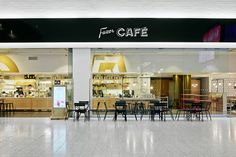 the inside of a cafe with tables and chairs