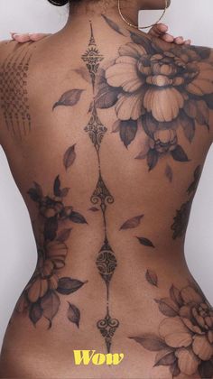 the back of a woman with tattoos on her body