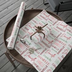 two napkins on top of a wooden table with scissors and paper wrapped around them