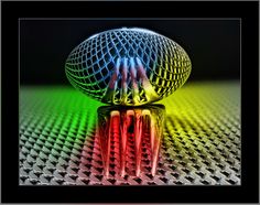 a disco ball sitting on top of a table with its reflection in the glass surface