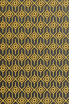 a black and gold background with an intricate design on the bottom right hand corner, which is repeated in rows of hexagonal shapes