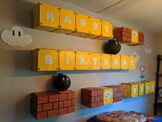 a room with lego blocks and decorations on the wall, including a happy birthday sign