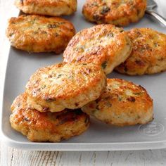 some crab cakes on a plate with a fork