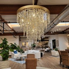 a living room filled with furniture and a chandelier hanging from it's ceiling