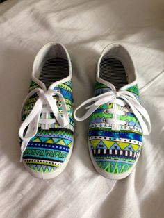 pair of colorful shoes sitting on top of a bed