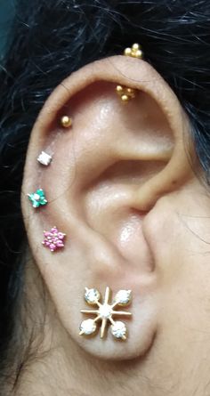 an ear with three different colored jewels on it