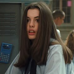 a woman with long brown hair holding a calculator