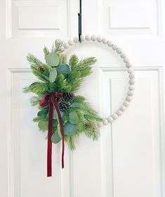 a wreath hanging on the front door of a house