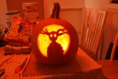 a carved pumpkin with an image of a deer on it