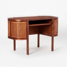 a wooden desk with a rattan design on the top and bottom section, sitting against a white background