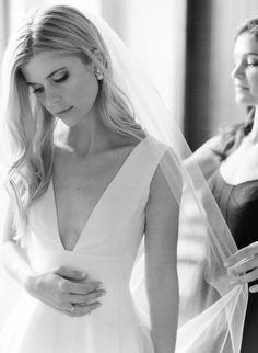 the bride is getting ready to walk down the aisle in her wedding dress and veil