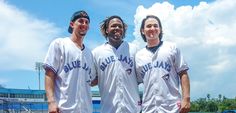 three baseball players are posing for a photo