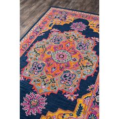 a blue rug with an orange and pink design on it