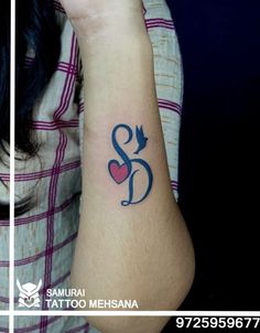 a woman's arm with a tattoo on it that has an arrow and heart