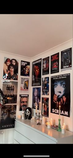 a room with posters and candles on the wall