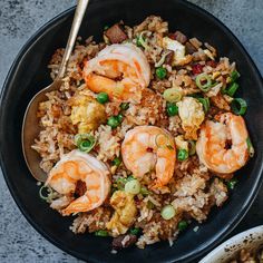 two bowls filled with rice and shrimp on top of a table