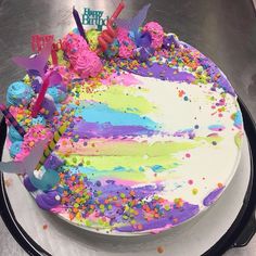 a birthday cake decorated with sprinkles and decorations