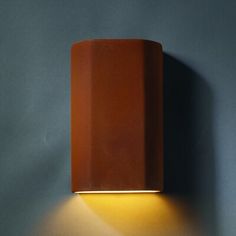 a wall mounted light on the side of a gray wall