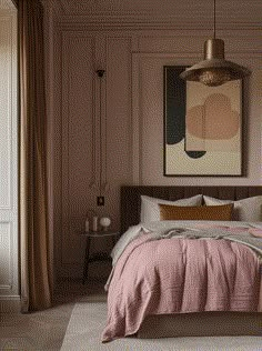 a bed with pink sheets and pillows in a bedroom next to a painting on the wall