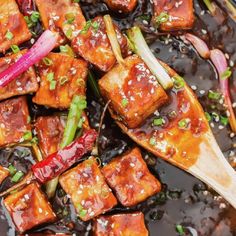 tofu and onions in sauce with chopsticks on the side, ready to be eaten