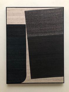 an abstract painting with black and white lines on the bottom half of it, against a white wall