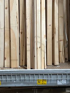 some wooden boards are stacked on top of each other and ready to be put into storage