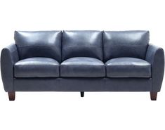 a blue leather couch sitting on top of a white floor