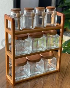 a wooden spice rack filled with glass bottles