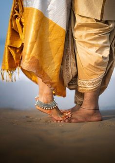 two people standing next to each other on the beach