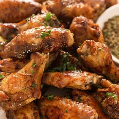 chicken wings with herbs and seasoning on a white plate