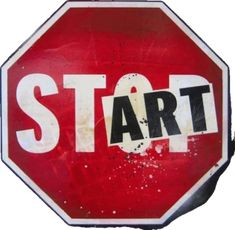 a red stop sign with the word start painted on it's bottom and underneath