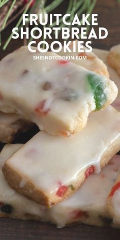 a pile of shortbread cookies sitting on top of a wooden table next to pine branches