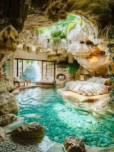 a bedroom with a pool in the middle and lots of rocks on the ground around it