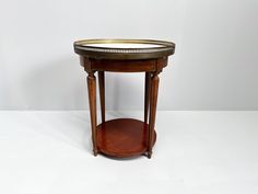 a small wooden table with a mirror on it's top and shelf underneath the table