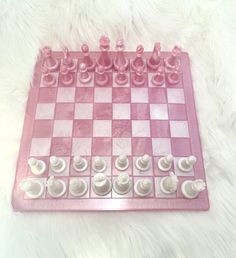 a pink and white checkerboard game set on a furnishing area with the pieces laid out