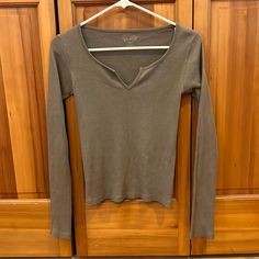 This Classic Long Sleeve Top Is Complete With A Notched V-Neckline And A Regular Fit. Basic Clothing Items You Need, 2000s Long Sleeve Shirt, Brandy Long Sleeve, Brandy Melville Christy Hoodie, 2010 Fits, Shifting Closet, Brandy Melville Sweatshirt, Brandy Melville Hoodie, Christy Hoodie