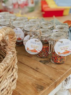 there are many glass jars with different types of confetti in them on the table