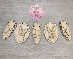 three wooden cutouts of different animals on top of a wood table next to a sign that says diy craft kits