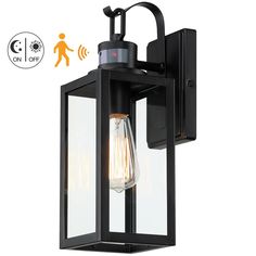 a black outdoor light with an image of a person walking