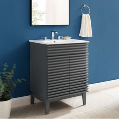 a bathroom with blue walls and a black cabinet next to a white sink under a mirror