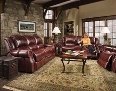 a woman sitting on top of a couch in a living room