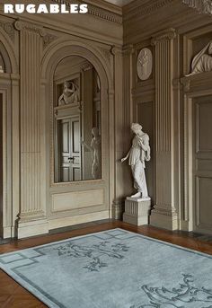 an ornate room with statues and rugs on the floor