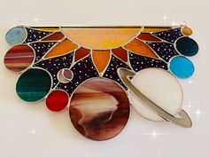 the solar system is made up of stained glass and sunbursts, including saturn