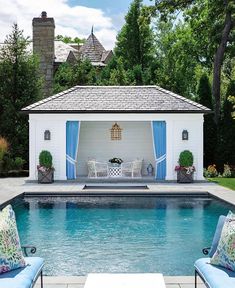 a pool with two chairs and a gazebo