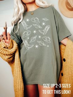 Get obsessed with the Cowgirl Aesthetic with this cute Space Cowgirl Shirt! This Cosmic Comfort Colors® Tshirt is super comfy! Size up for a Trendy Oversized Look! ♥ Hello and Welcome to Meaningful Tees Shop! ♥ Models are wearing Comfort Colors® Khaki, Ivory and Washed Denim. ♥ All of our items are made one at a time with care for each customer : ) ♥ Please allow 3-7 BUSINESS days (usually 3-5) for your item to be created PLUS shipping time via USPS ♥ UNISEX TEES fit like a Mens Shirt on Women, but are not overly large. ♥ For a RELAXED FIT, your usual size will typically work, but please consult the Size Chart in the Listing Photos ♥ For a TRENDY OVERSIZED FIT, size up 1, 2, or 3 Sizes! (2 sizes up is most common) ♥ For a SNUG FIT, size down 1 size. ♥ When in doubt, lay your favorite Tshir Scene Shirt, Design Tshirts, Space Cowgirl, Balls Shirt, Cowgirl Aesthetic, The Only Exception, Comfort Colors Tshirt, Cowgirl Shirts, Disco Balls