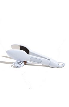 a white hair dryer sitting on top of a white floor next to a cord