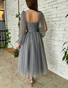 Details:- Starry tulle fabric in a pastel grey hue- Hearty corset top, with built-in pads and boning- Draped bodice- Cinched waist- Inseam pockets- Midi-length skirt- Decorative cape, gathered at the neck and with a tied spaghetti bow-Opti... Tulle Puff Sleeves, Black Formal Gown, 2022 Prom Dresses, Capelet Dress, Prom Dresses 2022, Night Clothes, Tulle Maxi Dress, Draped Bodice, Satin Homecoming Dress