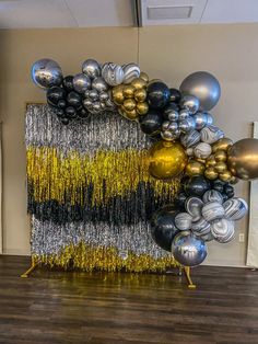 balloons and streamers are on display in an office space with wood flooring,