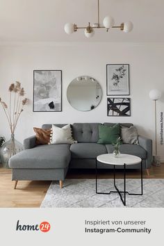 a living room filled with furniture and pictures on the wall