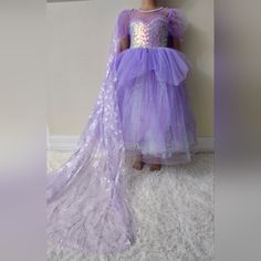 "Newwith Tag" Transform Your Little One Into A Dazzling Princess With Our Magical Lavender Princess Dress. This Enchanting Dress Features A Heart-Shaped Sequined Bodice That Shimmers With Every Move. The Dreamy Lavender Tulle Skirt Is Adorned With Glittery Castle And Firework Designs, Making It Perfect For Playtime, Special Occasions, Or Dress-Up Parties. Festive Princess Tutu Dress For Dress-up, Festive Princess Style Tulle Dress, Festive Princess Tulle Dress, Lavender Princess Dress For Dress-up, Festive Princess Dress, Purple Tulle Dress For Dress-up, Lavender Princess Dress For Dress-up Occasions, Lavender Tulle Princess Dress For Dress-up, Lavender Tulle Dress For Dress-up